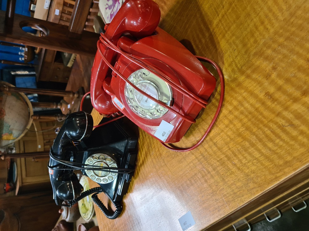 An old red telephone and one other black example