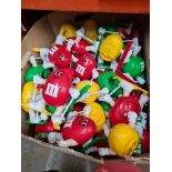 A box of M & M's sporting dispensers, mainly ski-ing