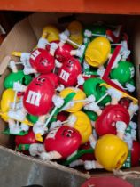 A box of M & M's sporting dispensers, mainly ski-ing