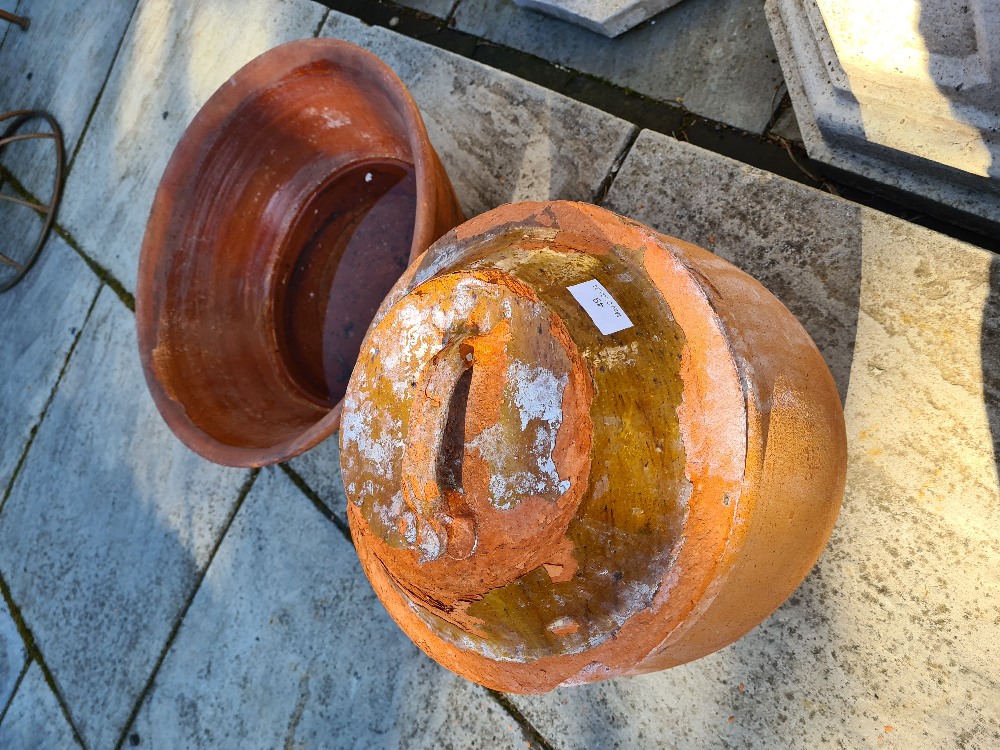 A partially glazed terracotta pot with lid and a large bowl