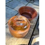 A partially glazed terracotta pot with lid and a large bowl