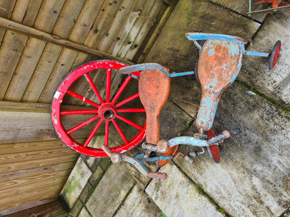 Two vintage child's tricycles, Tri-Ang in style and a small wagon wheel