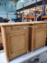 A pair of stripped pine bedside cupboards