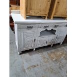 An early 20th Century painted sideboard having carved decoration, 155cm