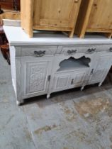 An early 20th Century painted sideboard having carved decoration, 155cm