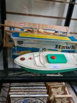 A Sutcliffe Hawk clockwork boat (remains of box - damage to boat - no key) and boxed Uffa Fox vintag