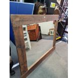 A large wall mirror with driftwood style frame