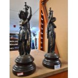 A pair of 19th Century style bronzed figures holding urns, 36cm