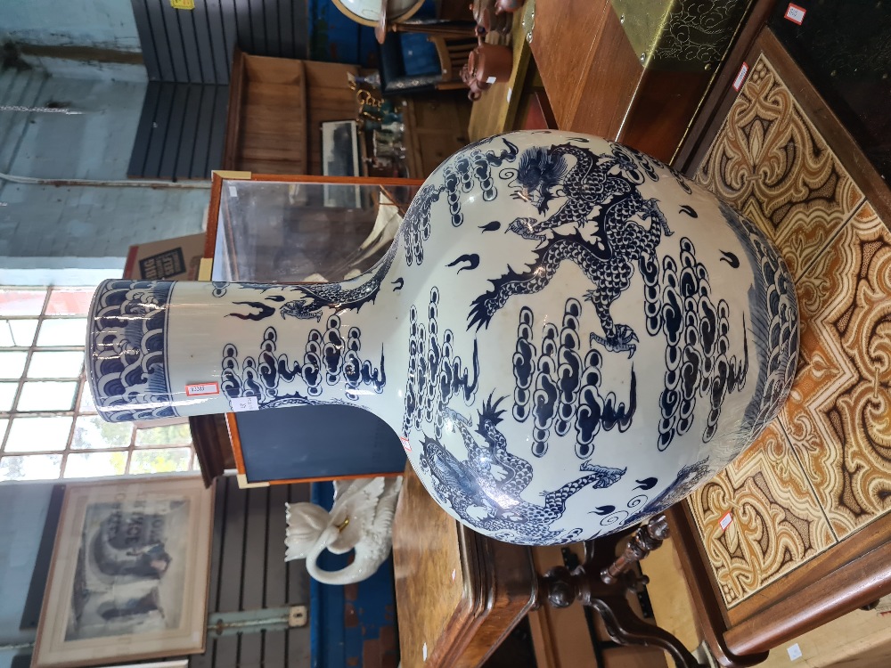 A large 20th Century Chinese blue and white vase decorated dragons, 60cm approx