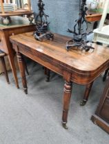 A Victorian rosewood foldover card table on turned legs