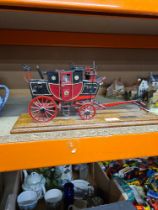 A wooden model of a Royal Mail Coach from the early 19th Century, on wooden base