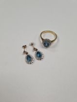 18ct yellow gold cluster ring with central oval blue topaz surrounded small diamonds, size P, approx