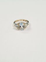 9ct yellow gold aquamarine dress ring with central oval cut aquamarine flanked two trillion cut exam