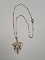 9ct yellow gold neckchain hung with an antique art nouveau design pendant set seed pearls and suspen