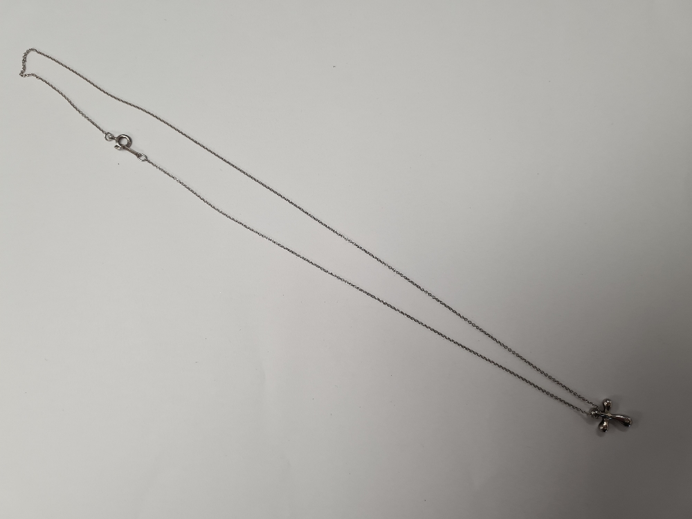 Tiffany & Co; A Sterling Sivler neckchain hung with Elsa Peretti small silver cross?