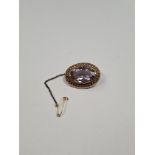 Antique 9ct yellow gold oval brooch, with large oval mixed cut amethyst, in 9ct 4 claw mount framed