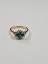 18ct yellow gold cluster ring comprising 4 round cut emeralds surrounded by small round cut diamonds
