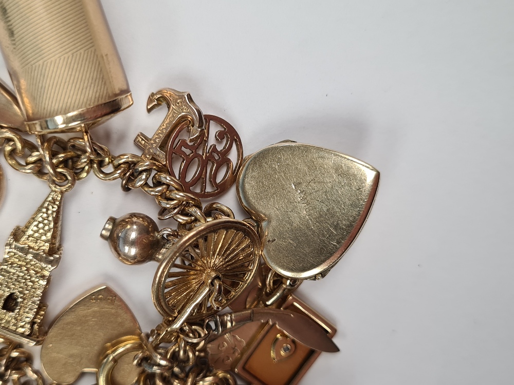 18ct gold bracelet hung with 23 charms, including 9ct and yellow metal, 9ct front and back locket, 9 - Image 2 of 4