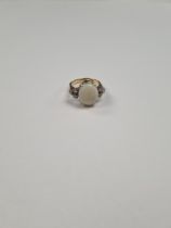 18ct yellow gold dress ring with large central white opal, each side supported 3 round cut claw moun