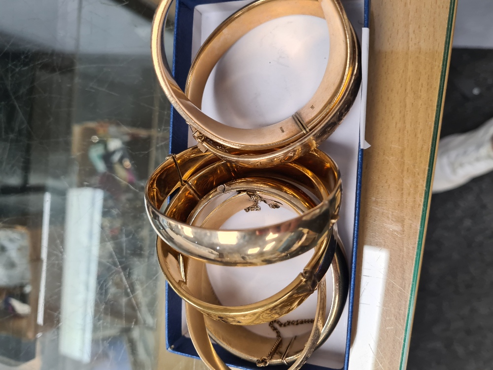 Six gold plated hinged bangles