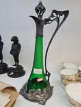 A WMF Art Nouveau decanter having pewter mounts of figures with green glass body