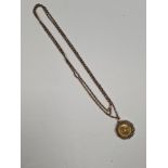 Long antique 9ct gold chain hung with a 22ct yellow gold 1912 Full Sovereign in 9ct gold mount, Sove