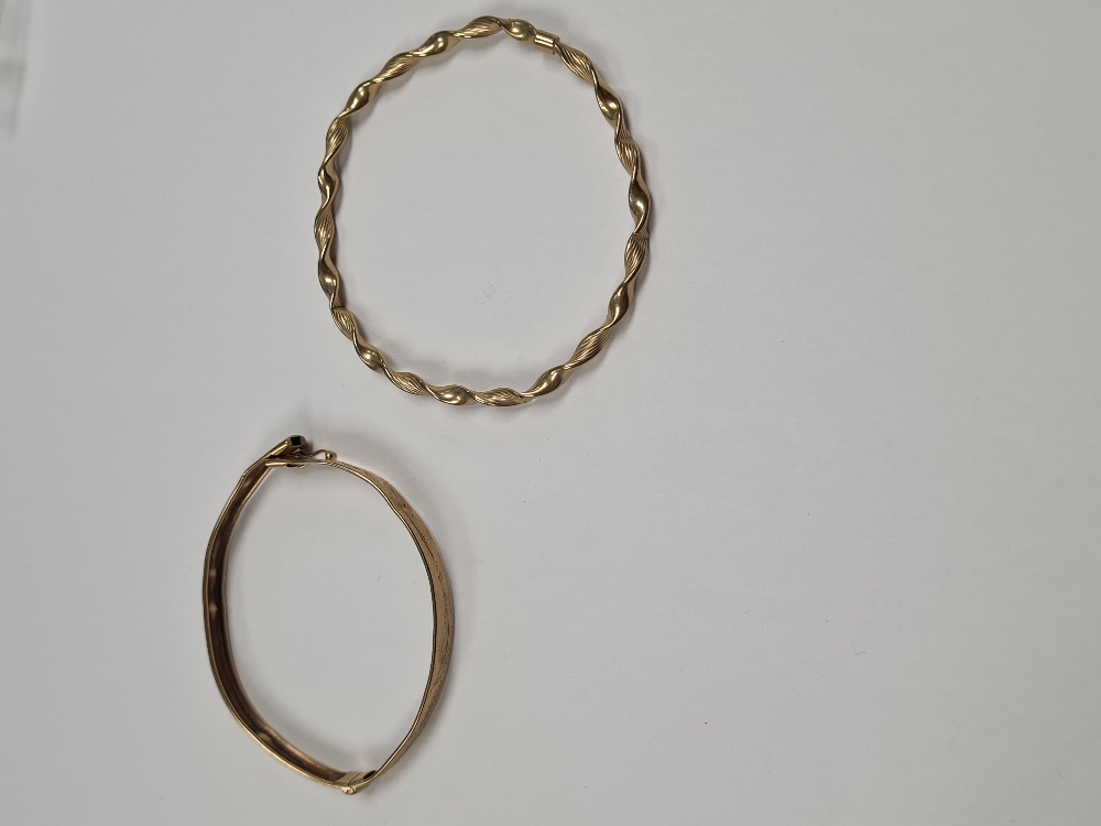 Two 9ct yellow gold bangles, both AF, one unmarked, hinged example marked 375, approx 9.4g