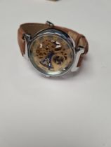 Louis Vuitton; A Louis Vuitton stainless steel skeleton watch, with golden works, blue hands 7347, o