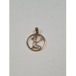 14ct yellow gold circular pendant of open form, depicting a kneeling female holding a heart, approx