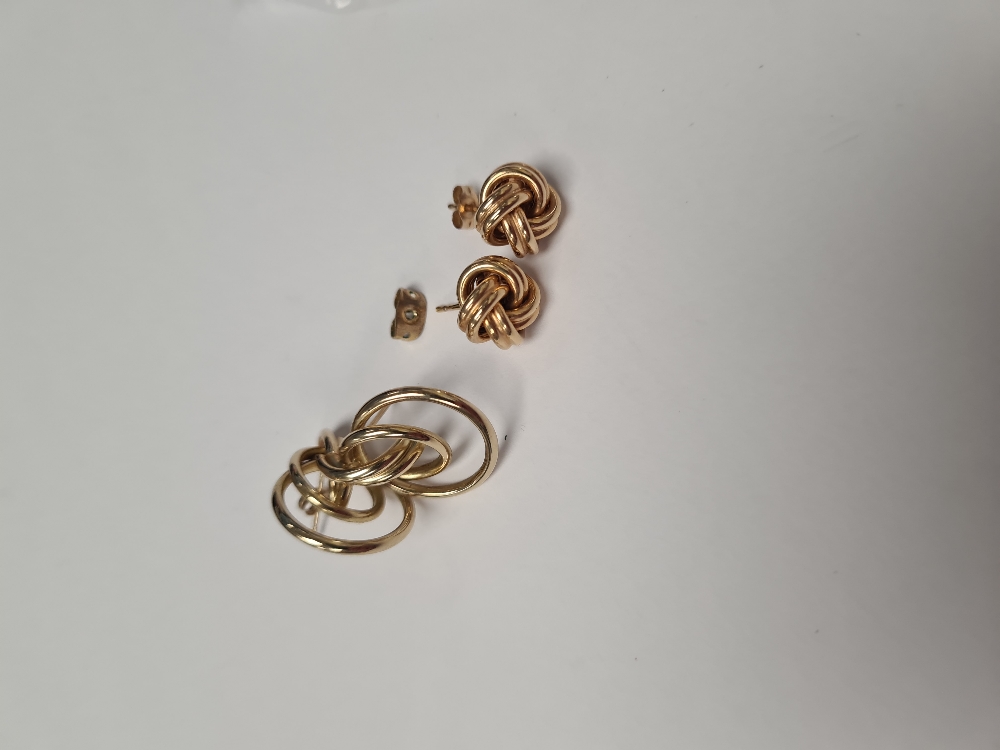 Pair of 9ct gold knot design earrings, marked 375, and a yellow metal pair of earrings, unmarked, ap