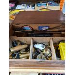 A wooden box with miscellaneous contents including coins, whistles and bullet casings