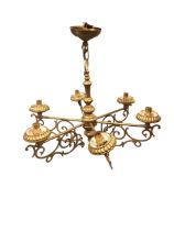 A hanging brass light fitting with six brackets supporting fluted lampholders with scrolled mounts