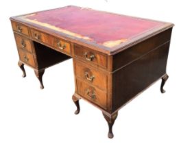 A mahogany pedestal desk, the rectangular gilt-tooled leather inset top above a frieze of three