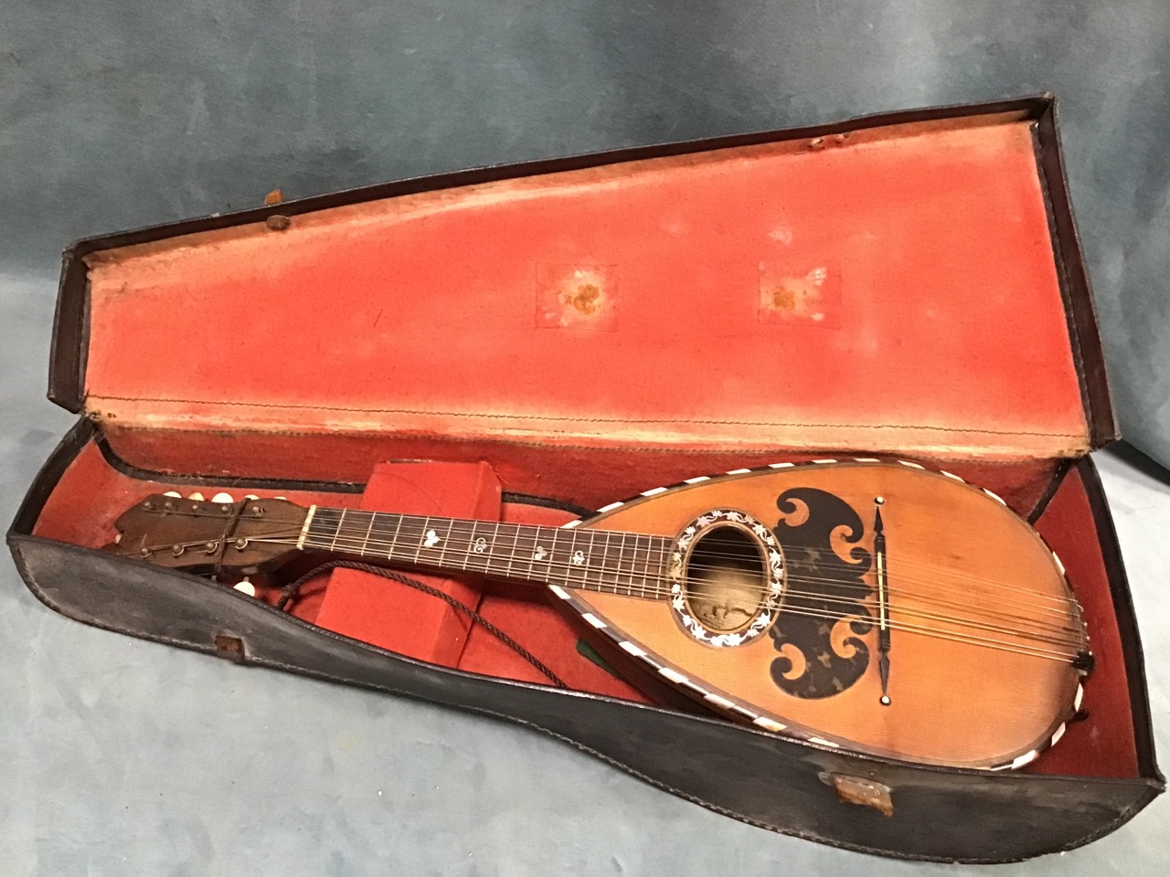 A C19th cased Neapolitan mandolin by Giuseppe Vinaccia, the pear shaped walnut ribbed back and