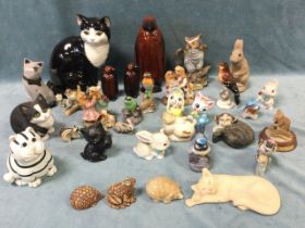 A collection of ceramic and other animal figures, including cats, dogs, penguins, rabbits,
