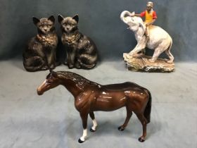 A Beswick ceramic chestnut stallion; a pair of Edwardian Staffordshire cats with green glass eyes