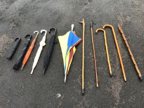 Six umbrellas, a hazel and antler thumb stick, a wrought iron and hazel crook, two walking sticks,