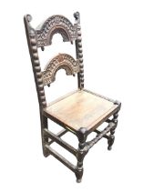 A C17th oak South Yorkshire back stool with two arched carved rails with acorn drops flanked by