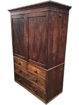 A C19th mahogany press, the moulded cornice above a pair of panelled doors enclosing shelves, the