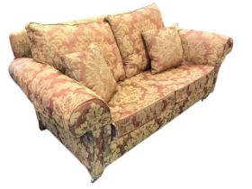 An upholstered two-seater country house sofa, the rectangular back and seat with loose cushions,