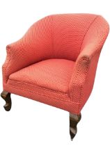 An Edwardian upholstered tub armchair, the horseshoe shaped back and arms above a conforming seat,