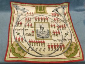 A Hermès silk scarf titled Sonneurs de Trompe, depicting hunting hounds, horn blowers, a stag, etc.,
