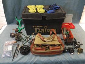 A Daiwa fishing tackle box containing miscellaneous reels, floats, lures, a canvas fishing bag, a