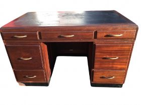 A 50s mahogany kneehole desk by Baldock & Sons, the moulded caddy top with writing surface above