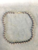 A 9ct gold and haematite bead necklace, with a 9ct lobster clasp. (16in)