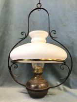 A Victorian hanging brass oil lamp, the Duplex burner converted to electricity, having a wrought