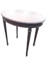 An Edwardian mahogany Adams style oval occasional table, the moulded top above a fluted apron raised