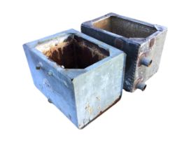 Two rectangular galvanised tanks with flat rims and reinforced top corners, one of riveted