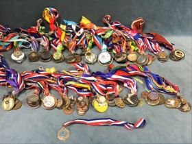 A collection of ribboned medals or medallions, mainly contemporary sporting, bronze, gilt metal,