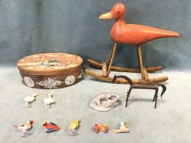 A carved wood and gesso toy rocking duck, an oval Norwegian bent larch box painted with a nativity